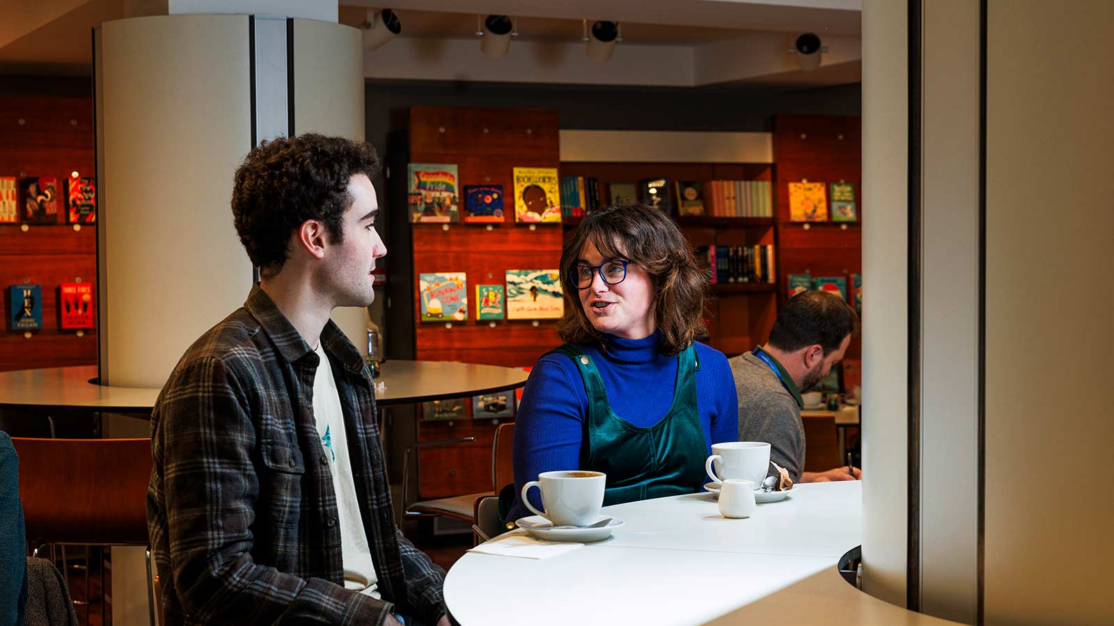 Two people sitting and having a coffee in the Library cafe