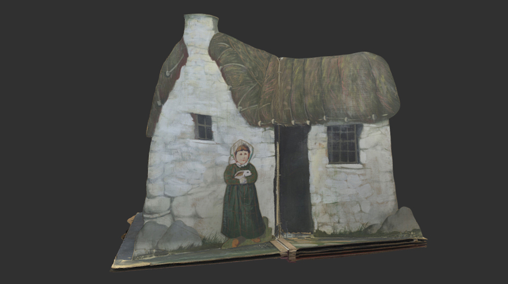 Stage set two showing a child standing outside of a house holding a rabbit.