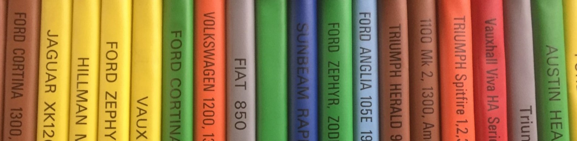 Colourful spines of books about cars.