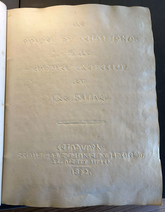 An embossed title page in a special alphabet.