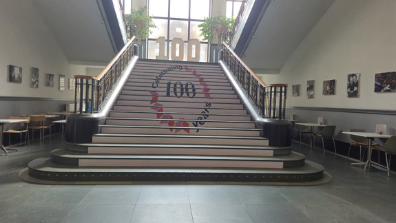 Stairs leading up. They are very wide with hand rails either side.