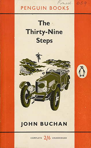 An older style of car sits in the foreground while a man runs along a path toward it in the background.
