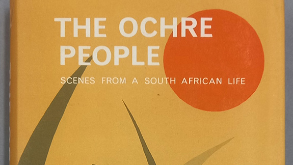 Book cover for 'The Ochre People'. It has warm colours with an orange sun in the corner and plants growing up from the bottom.
