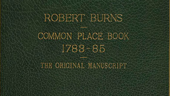 Dark green leather book cover with gold letters.