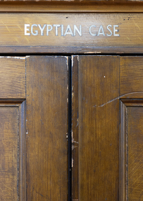 The words "Egyptian case" painted onto the wood of the case.