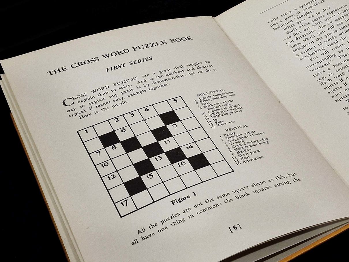 Close-up of the crossword book, open at the page revealing step-by-step instructions in how to fill in a crossword puzzle.