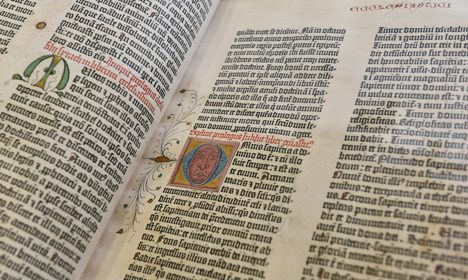 An opened Gutenburg Bible showing embellished letters.