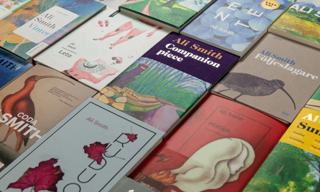 Lots of books by Ali Smith spread out on a table.