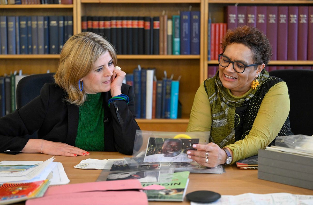 Amina Shah and Jackie Kay looking at Jackie's archive together.