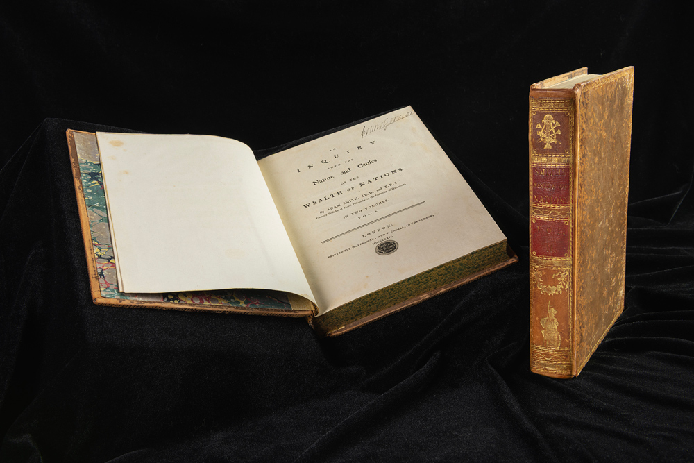 'The Wealth of Nations' book by Adam Smith open on the title page.