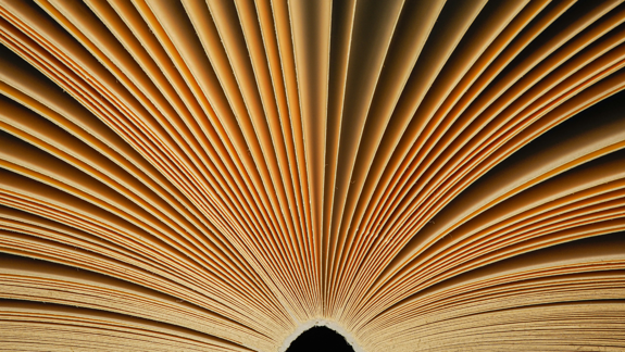 A book open with all its pages splayed out.