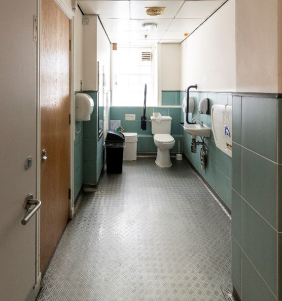 Interior photo of an accessible public bathroom, including baby changing facilities.
