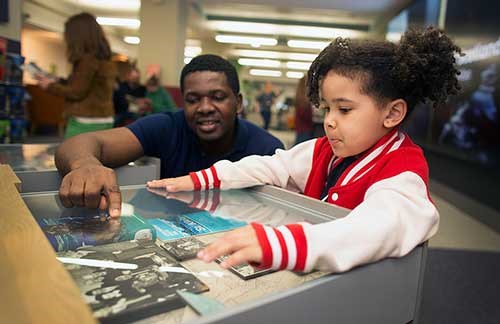 Man and child looking at exhibits