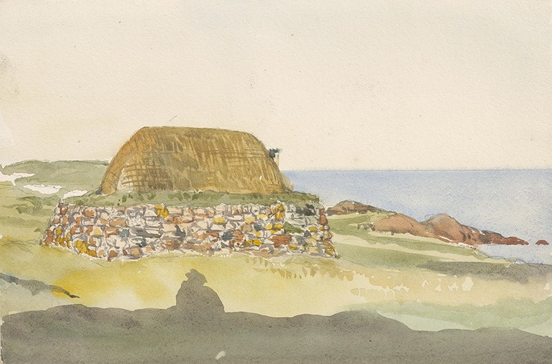 A small thatched house surrounded by rocks facing the sea