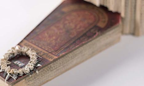 A small flat, angled sculpture of a book
