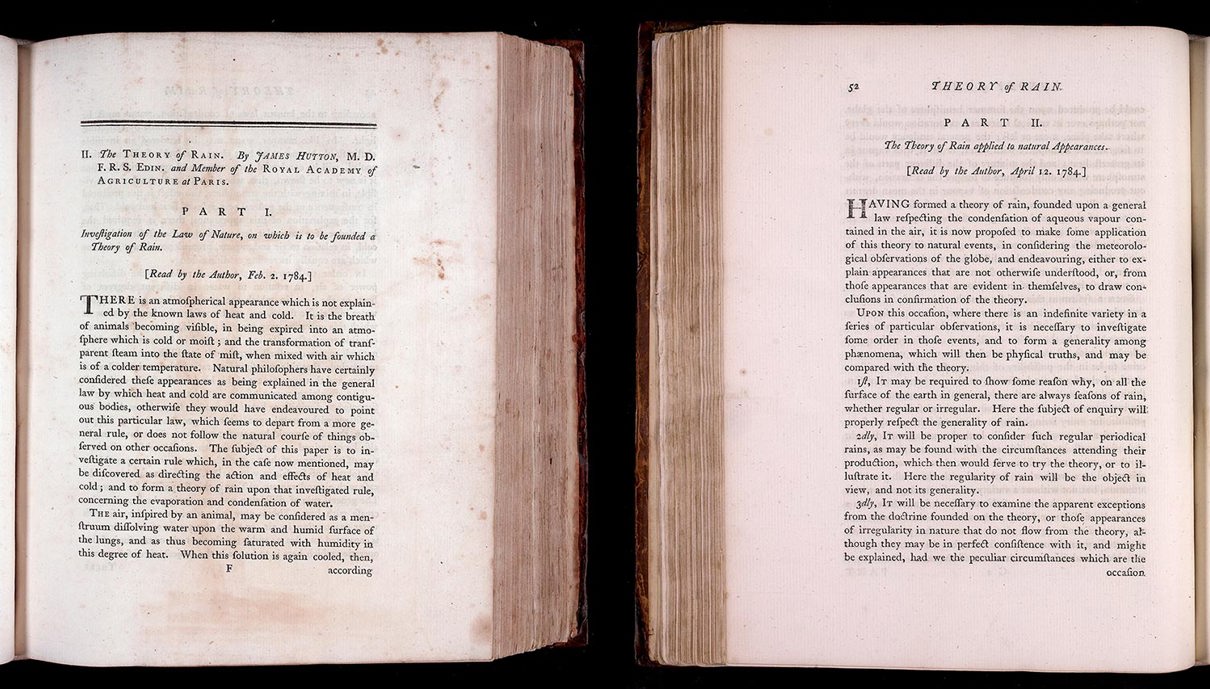 Two books with their pages open to the first pages of part one and part two of 'The Theory of Rain'.