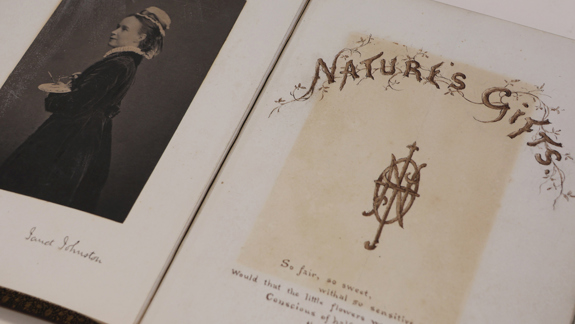 An open book with a black and white photo of a woman on the left and a title page on the right saying "Nature's Gifts".