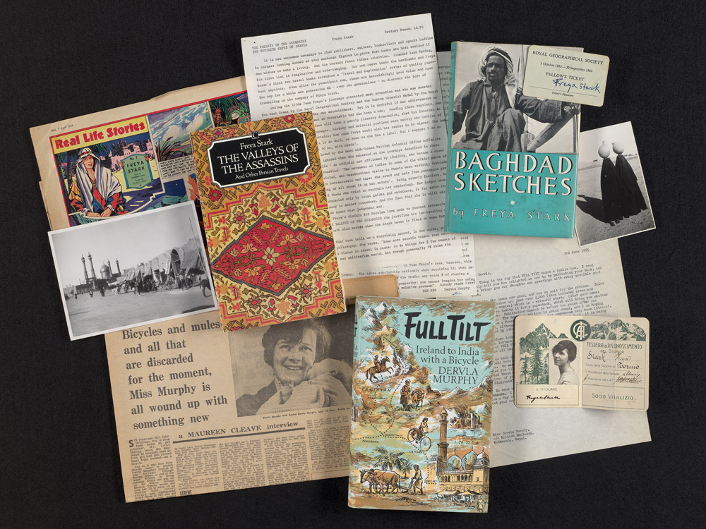 A collection of ephemera including typed documents, books, and newspaper cuttings.