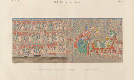 Engraving of an ancient Egyptian wall relief depicting a ruler in a chariot with hieroglyphic inscriptions and figures in procession.