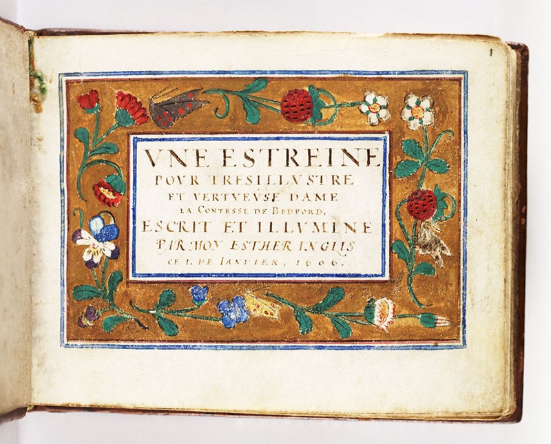A frontispiece glued on a page in a book with Latin text in the middle surrounded by a colourful flower border.
