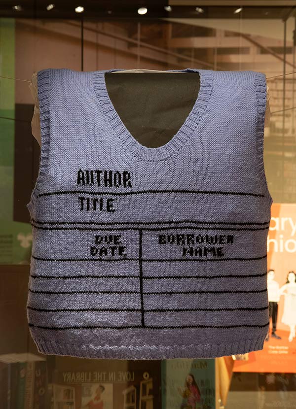 A hand knitted sweater that looks like a borrowing record found in a library book