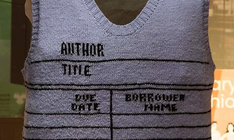 A hand knitted sweater that looks like a borrowing record found in a library book