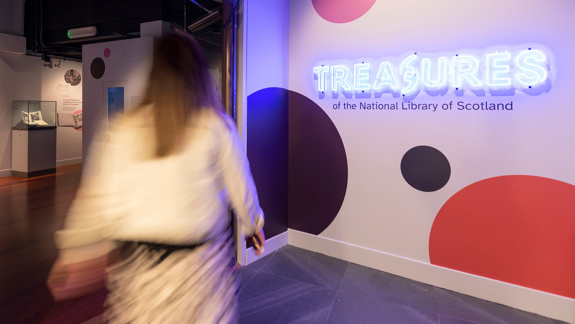 A person walking into the Treasures exhibition.