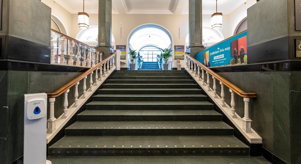 Interior photo of the main entrance staircase to the ground floor of the National Library of Scotland.