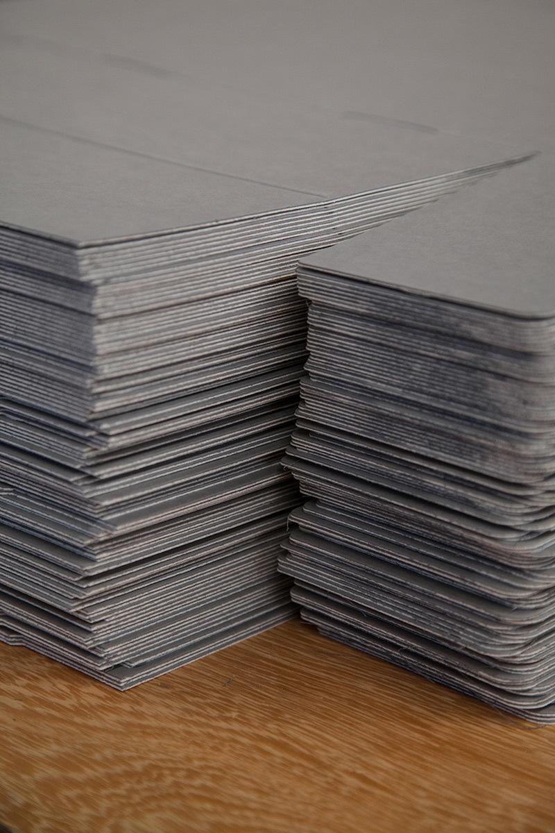A pile of grey carboard stacked up.