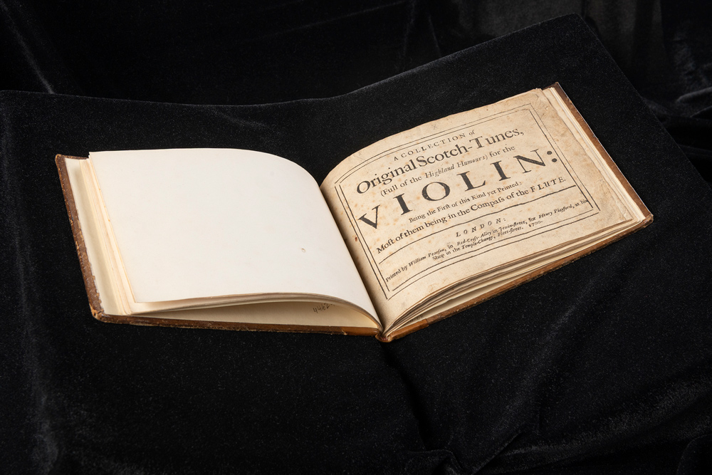 A book opened to the title page called 'Original Scotch-Tunes'.