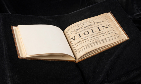 A book opened to the title page called 'Original Scotch-Tunes'.