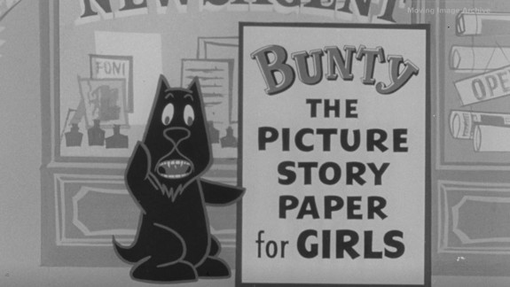 A cartoon black dog stands in front of a newsagent's shop window, pointing to a large sign that reads: 'BUNTY THE PICTURE STORY PAPER for GIRLS.' The shop window displays various items, including signs and newspapers.