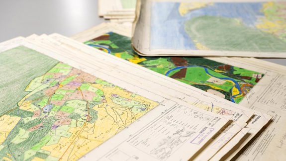 Several maps on a table.