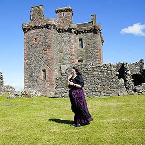 Person signing with ruins of a castle in the background