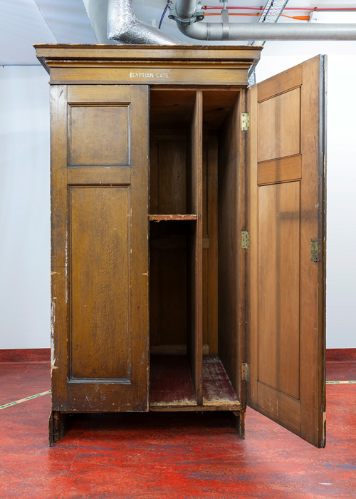 A brown wooden case, resembling a wardrobe.