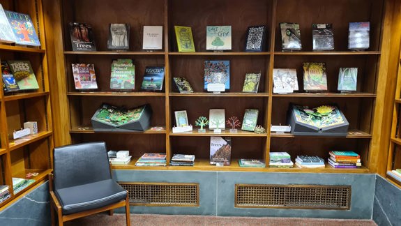 Bookshelves full of books about trees.