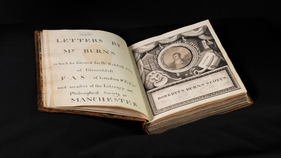 Robert Burn's Glenriddell Manuscript open showing the title page and portrait of him.