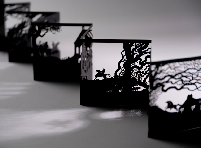 A black papercut concertina showing scenes from the story 'Tam O'Shanter' by Robert Burns.