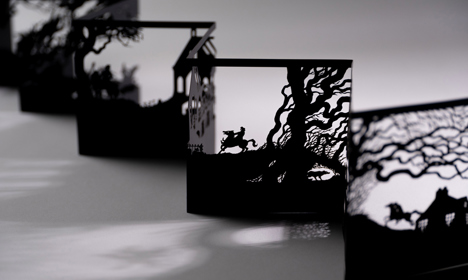 A black papercut concertina showing scenes from the story 'Tam O'Shanter' by Robert Burns.