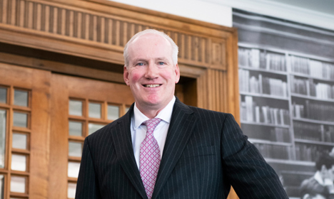 Donald Davidson standing on the stairs leading to the General Reading Room.