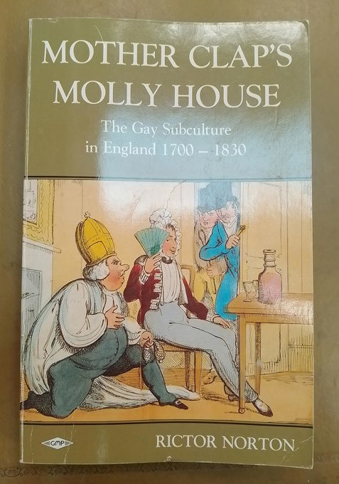 Book cover of 'Mother Clap's Molly House: The Gay Subculture in England 1700–1830' by Rictor Norton. The illustration shows three figures in 18th-century attire: one seated and holding a fan, with another kneeling beside him. Two others are squeezing through the door into the room.