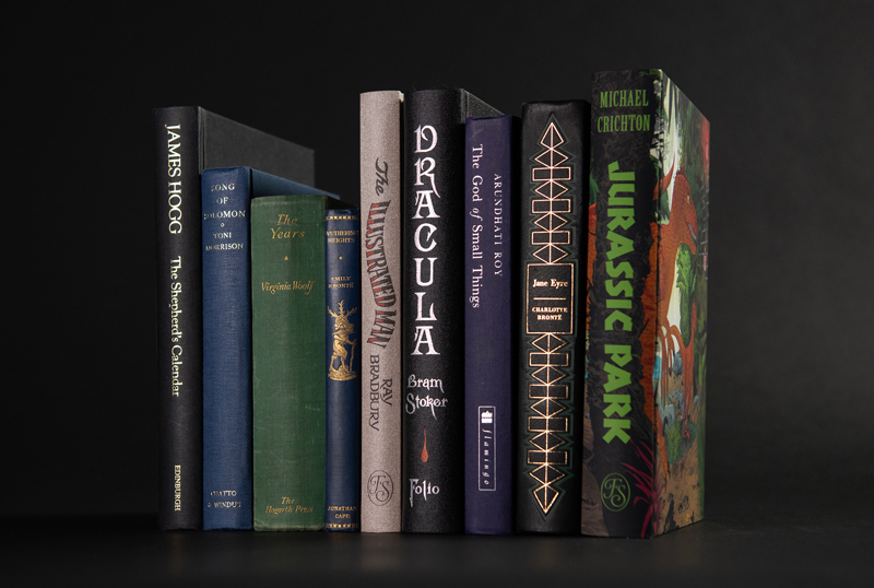 Several books lined up which have rain themes such as 'Dracula' and 'Jurassic Park'.
