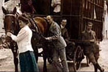 People standing around a horse and cart from 1909 in the Scottish Highlands.