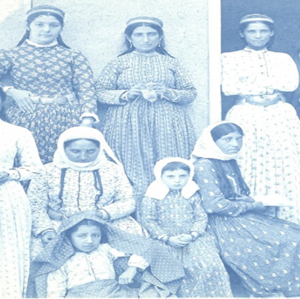 Black and white photo of women in old styles of clothing.