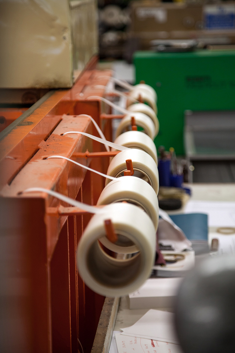 Lots of reels of tape hanging in a row.