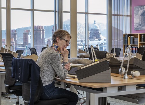 Person sitting at a desk inside the Special Collections Reading Room.