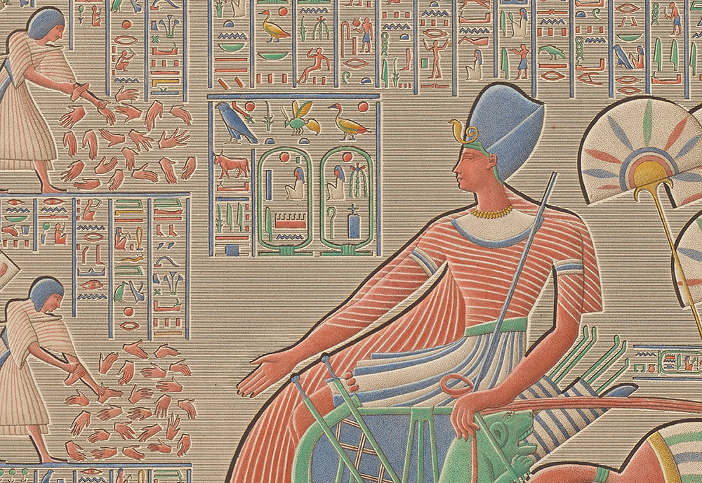 Closer view of the ruler in a chariot with hieroglyphic inscriptions around them.