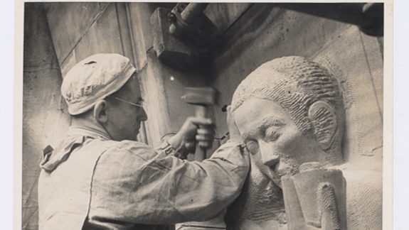 A man sculpting a stone figure.