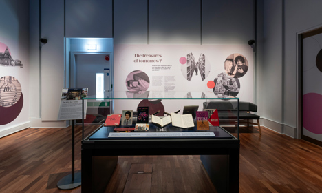 In the foreground, a display case showing Jackie Kay ephemera and in the background an exhibition panel asking "The treasures of tomorrow?".