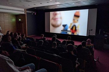 People sitting in a cinema watching a film.